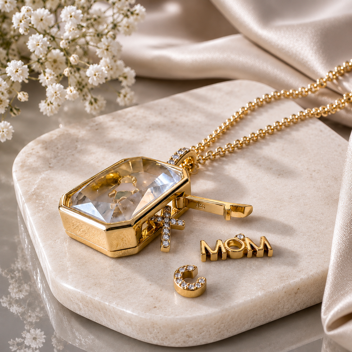 The Signature Story Charm Locket, open, with charms scattered around it